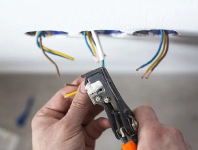 Plumber cutting pipe